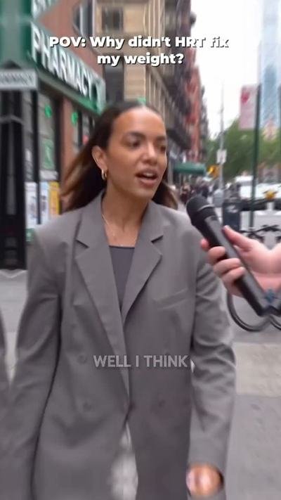 Woman being interviewed with a microphone on a city street