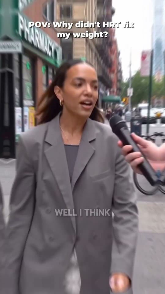 Woman being interviewed with a microphone on a city street